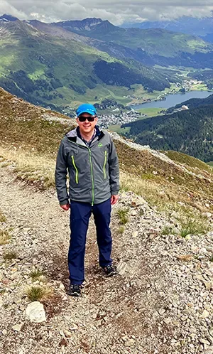 Ideal clothing for a summer tandem paragliding flight: hiking clothes with long trousers, a windproof jacket and hiking boots, high above Davos